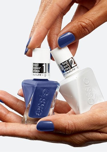 Medium skin hands holding a blue gel by essie nail polish bottle and a white bottle of gel top coat